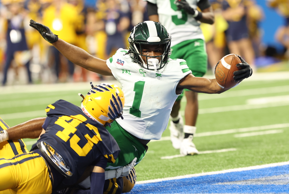 Detroit Cass Tech’s C.J. Sadler (1) stretches into the end zone for a touchdown during last year’s Division 1 Final at Ford Field. 