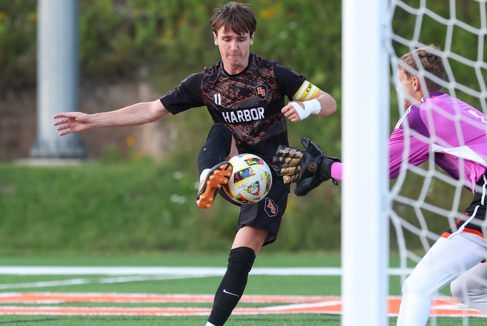 Harbor Springs’ Henry Juneau (11) works to get control of the ball in front of the net.
