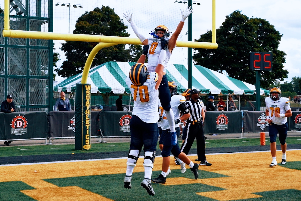 Clarkston players celebrate in the Wayne State end zone during their win over Belleville.