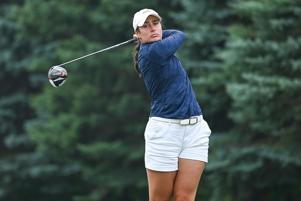 Kate Posey follows through on a golf swing with her driver. 
