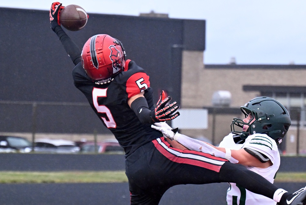 Marquette's Brody Clements hauls in a pass during his team's 41-13 win over Alpena.