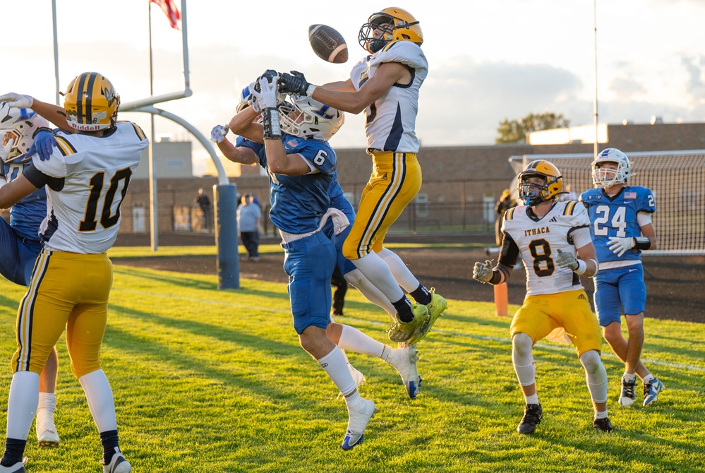 Ithaca and Lawton players attempt to reel in a pass during the Yellowjackets' Week 2 win. 