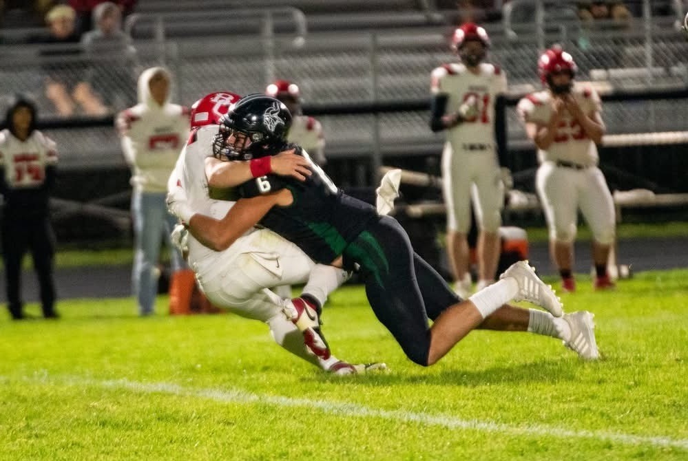Grayling’s Daniel Hunter wraps up a Benzie Central player during an incompletion in Week 2.
