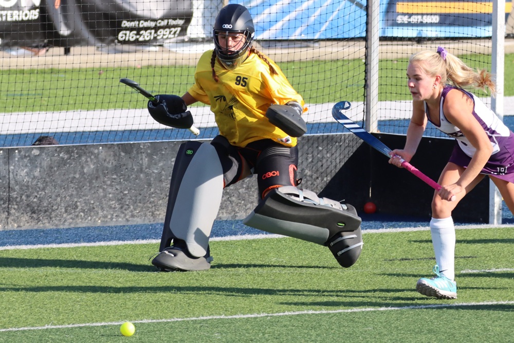 Saline's Kaylee Mitzel (in yellow) gets in position to defend her goal.