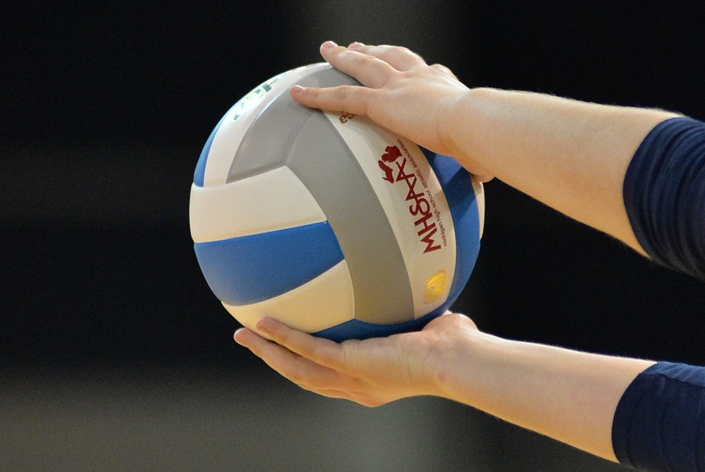 This is a photo of a volleyball player's hands holding a ball before a serve.