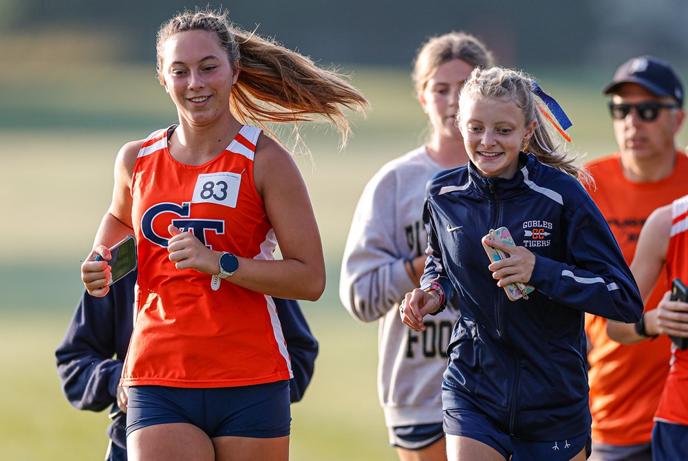 Gobles runners including Madison Cooley, front left, and Libby Smith warm up at the Portage Early Bird Invitational this season.