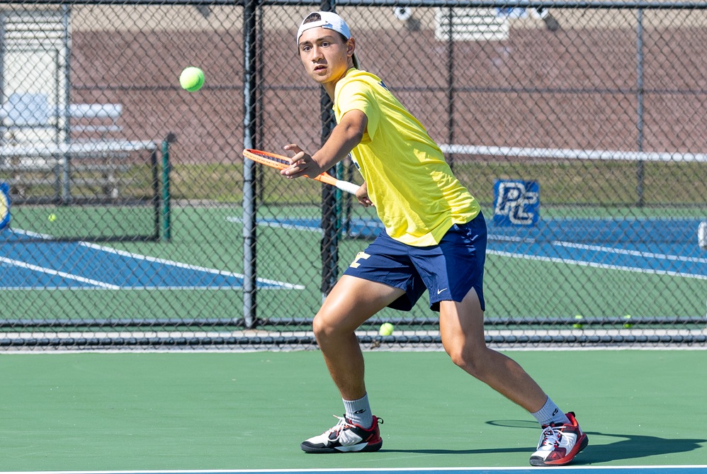 Portage Central tennis standout Sam Schumacher returns a volley.