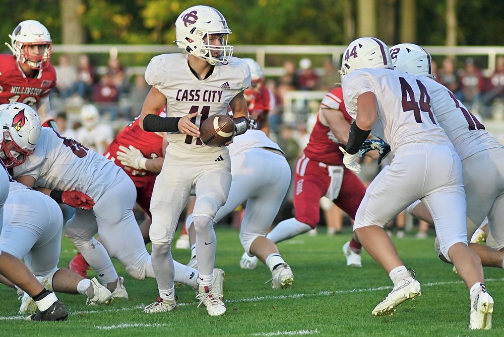 Cass City quarterback Preston Dorland (11) prepares to hand off to one of his backs during his team's 17-14 overtime win over Millington last week.
