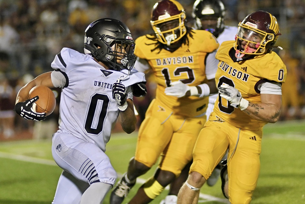 Davison defenders pursue a Saginaw United ball carrier during the Cardinals' 49-8 win Friday.