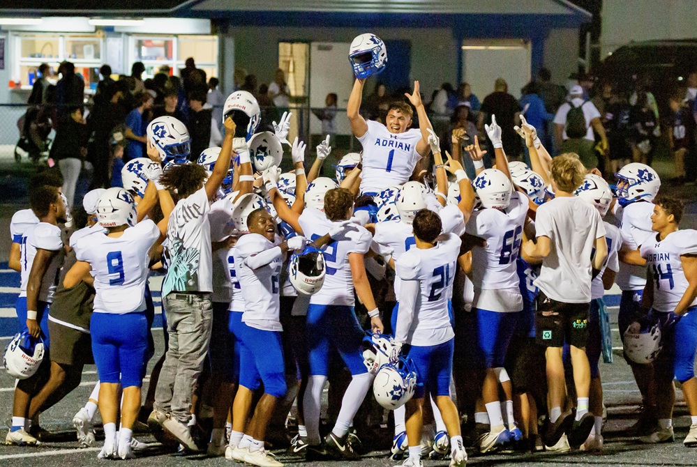 Adrian kicker Zack Hassan is carried by his teammates after making the game-winning field goal Friday against Ypsilanti Lincoln.