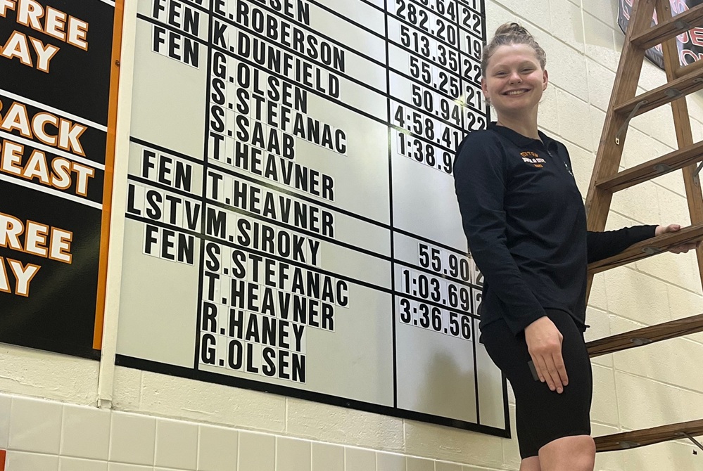 Fenton’s Katie Dunfield takes a photo with her addition to her school’s swim record board.