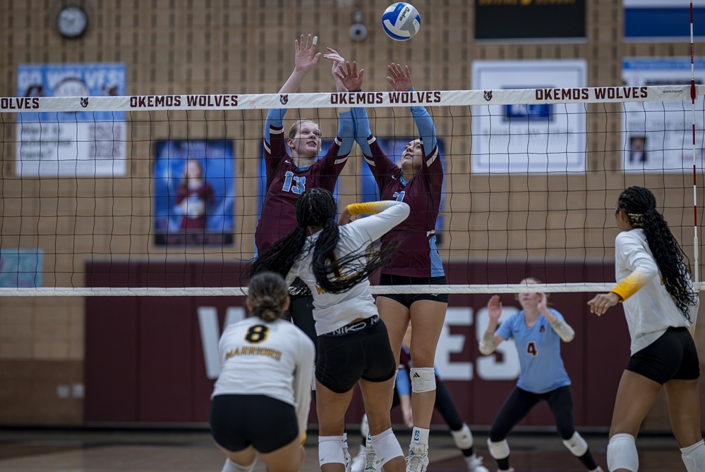 Okemos blockers attempt to deflect the ball during a sweep last week of Lansing Waverly. 