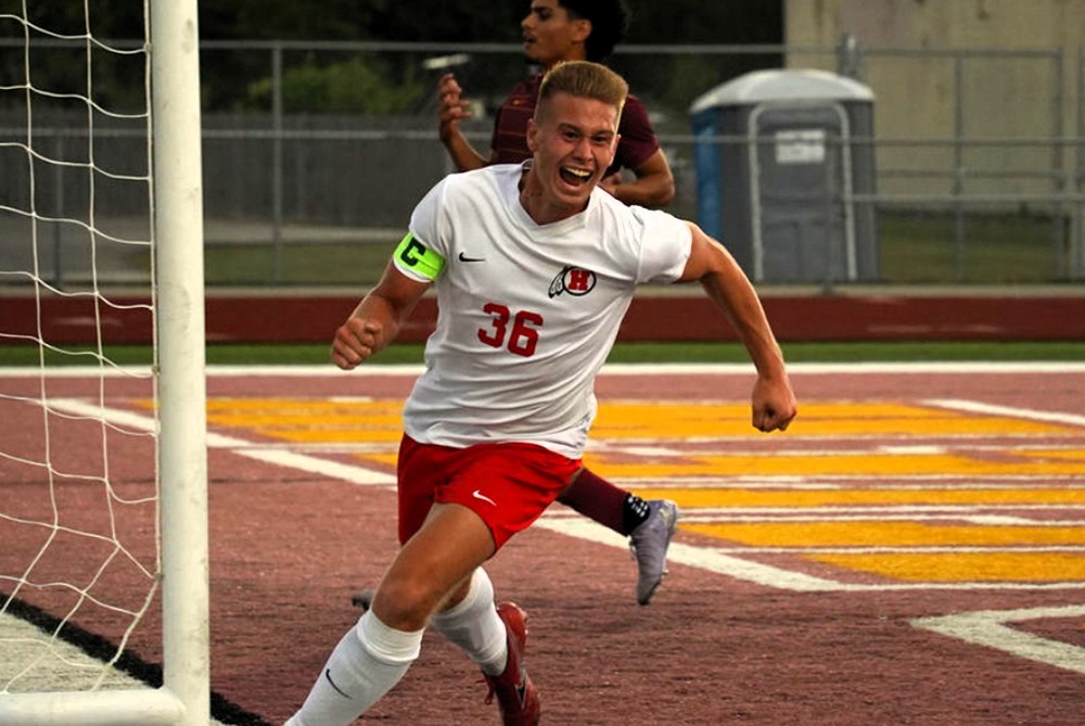 New Boston Huron’s Ian Petrick celebrates scoring a goal this season against Grosse Ile.