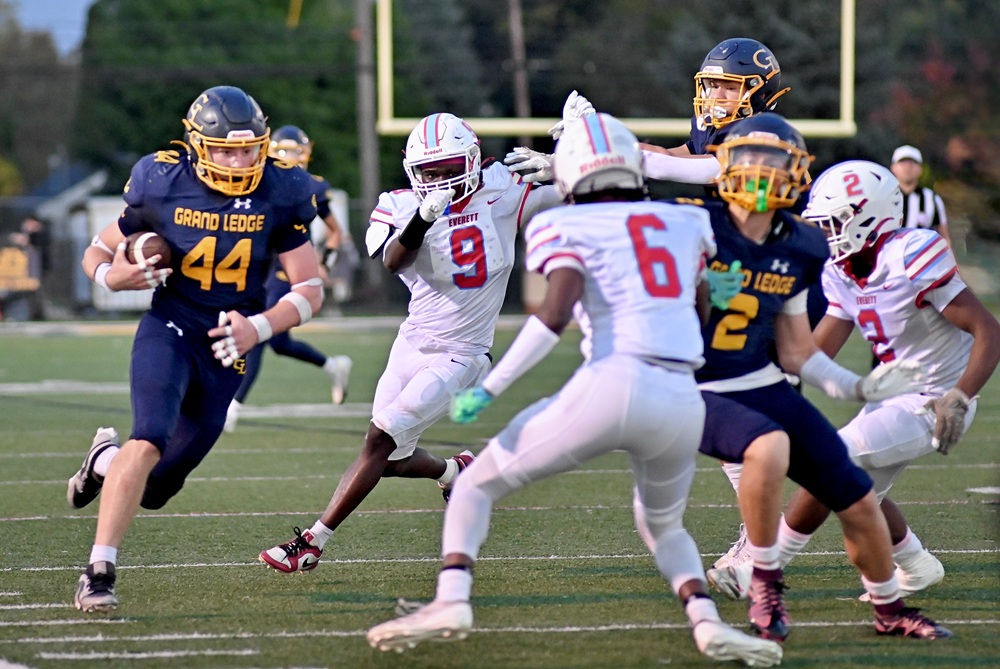 Grand Ledge ball carrier charges up the sideline Friday during his team's 36-8 win over Lansing Everett. 