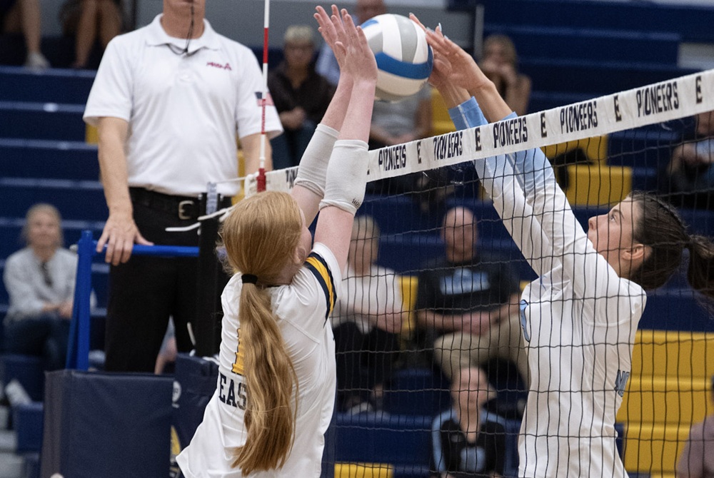 East Grand Rapids (left) and Forest Hills Northern players meet at the net during a match Sept. 23. 
