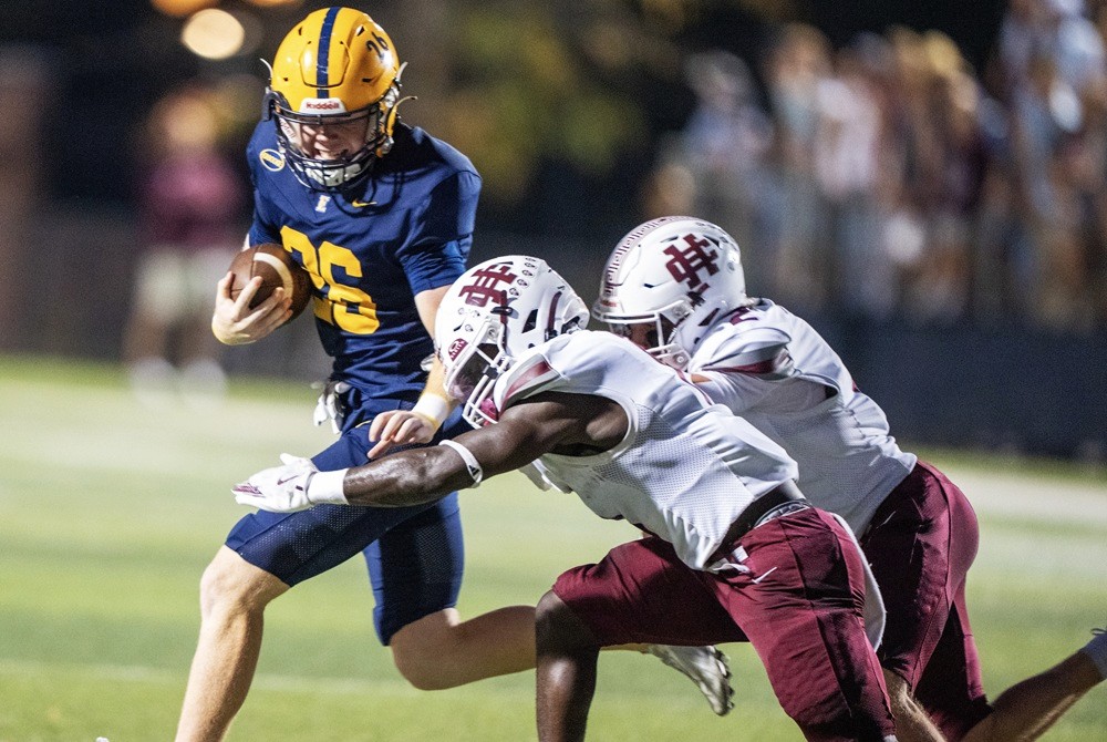  A pair of Holland Christian defenders pursue an East Grand Rapids ball carrier during the Pioneers' 41-21 win last week. 