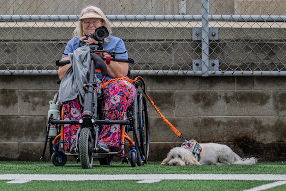 Longtime Traverse City St. Francis supporter Julie English readies for her next shot while attending a Gladiators football game this season.