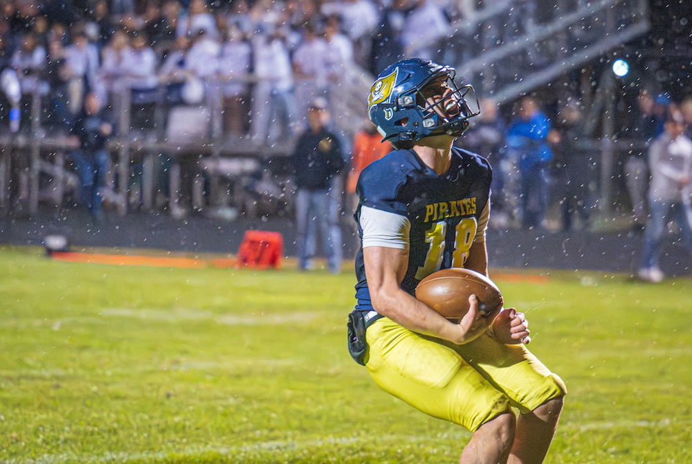 Pewamo-Westphalia's Ty Thelen celebrates a score in the rain during his team's win last week over Fowler.