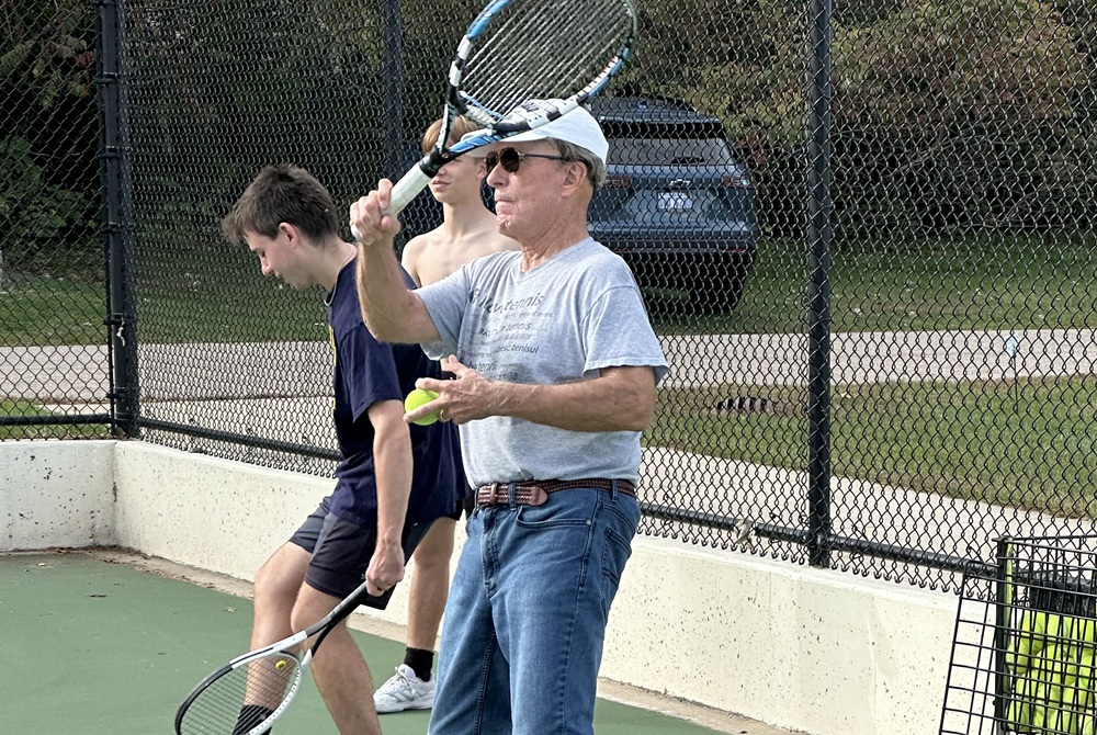 Richland Gull Lake tennis coach Roger Cornelius hits with his players during practice this season. 