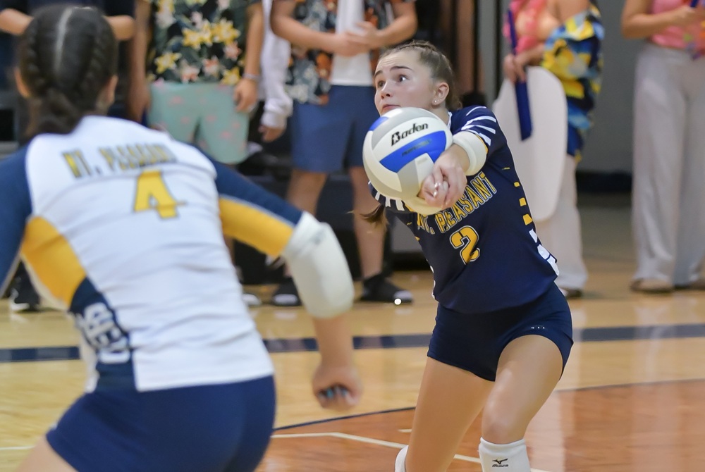 Mount Pleasant's Tessa Ervin (2) digs the ball during a match against Saginaw Heritage.