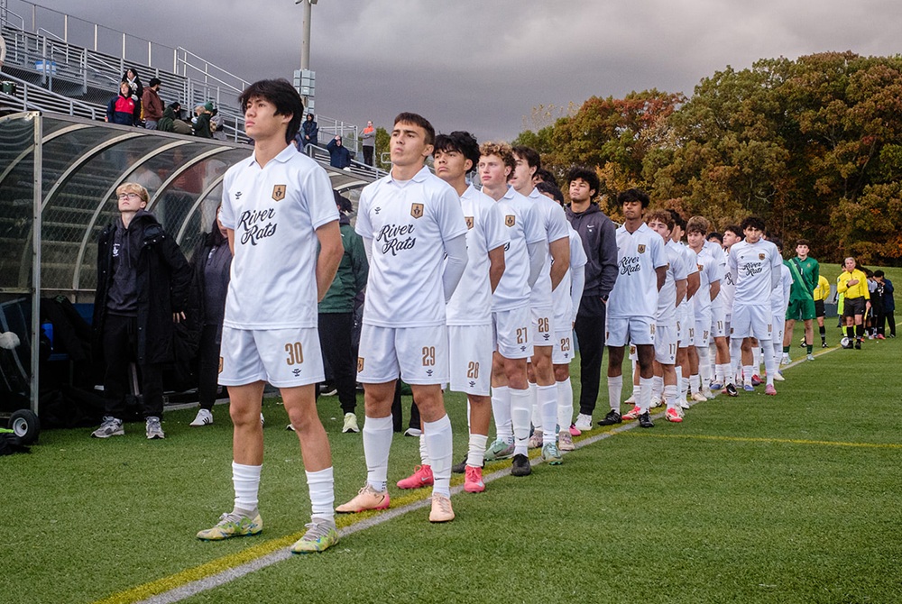  Ann Arbor Huron players stand for the national anthem before a game this season.