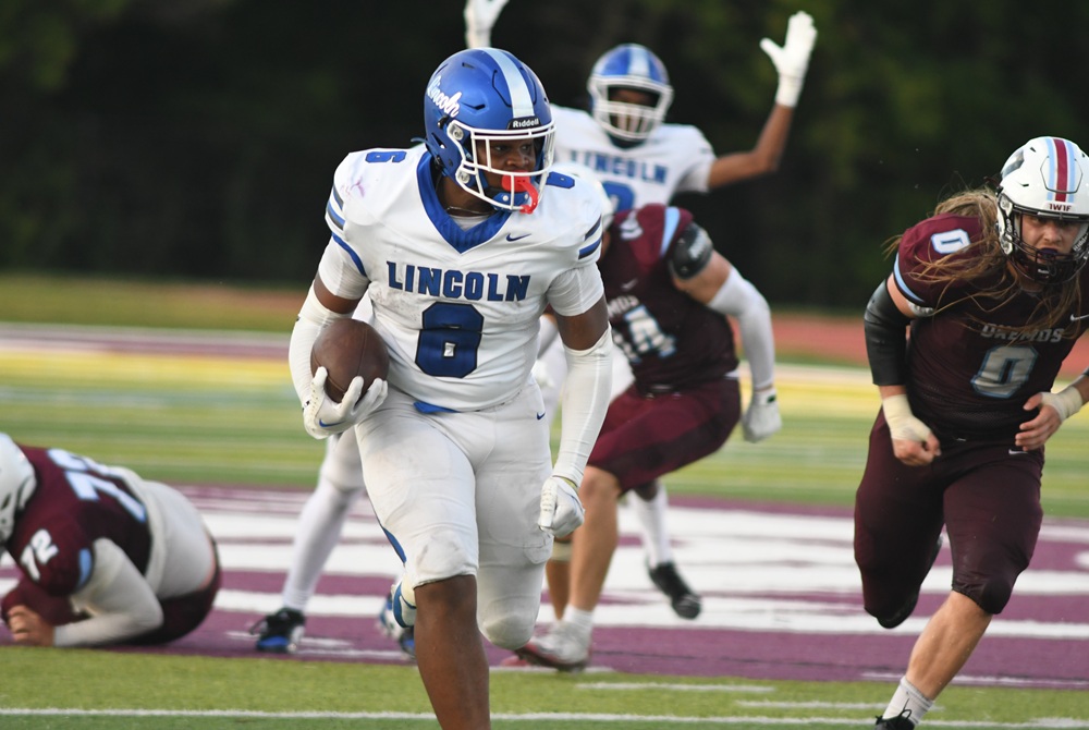 Ypsilanti’s Roshard Slater (8) breaks into the open during his team’s season-opening win over Okemos. 
