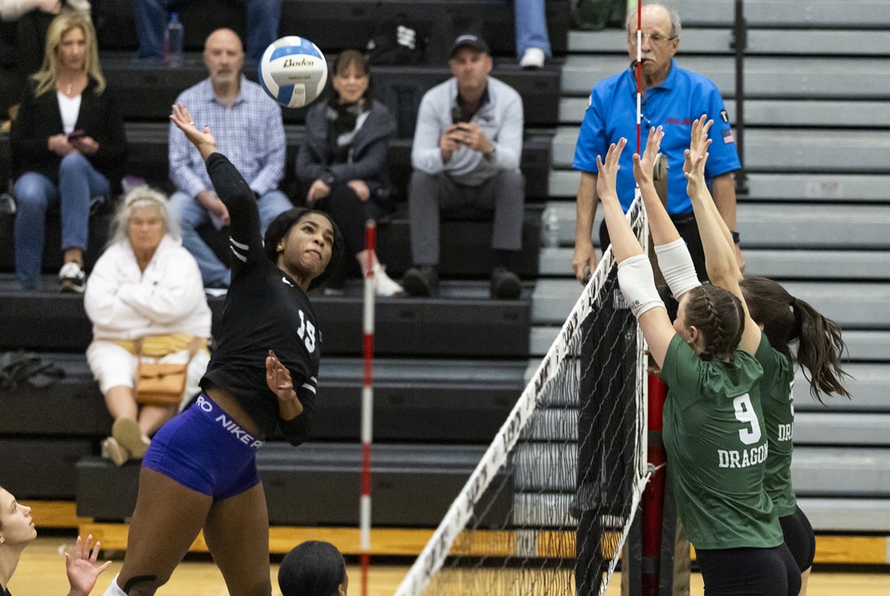 Bloomfield Hills’ Kayla Nwabueze (19) winds up for a kill attempt this season against Lake Orion. 