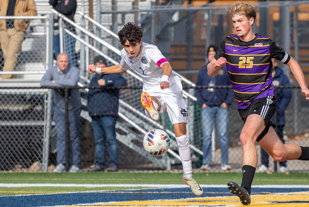Country Day’s Tino Haratsaris (2) connects on a shot while South Haven’s Isaac Chalupa (25) rushes to defend.