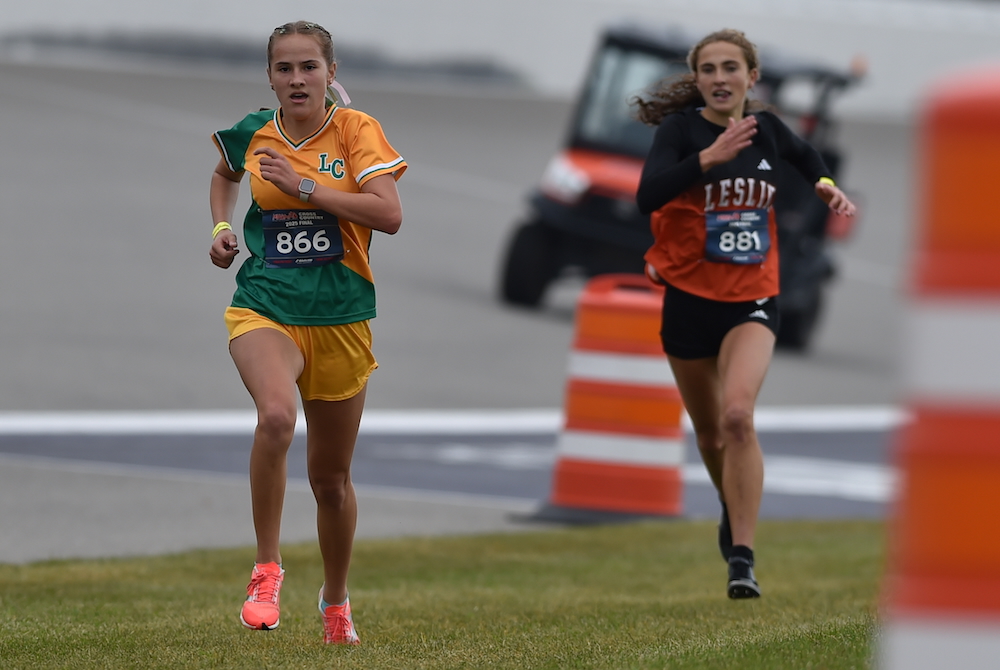 Jackson Lumen Christi’s Samantha Schroeder (866) pulls past Leslie’s Hailey Creisher during the closing stretch of Saturday’s Division 3 Final at Michigan International Speedway.