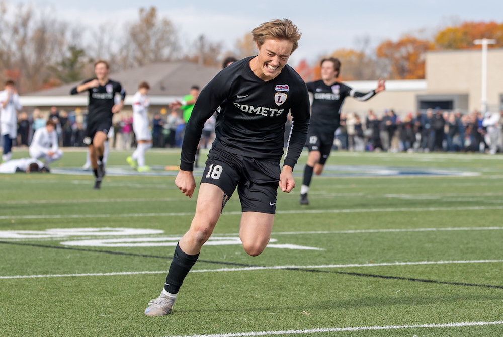 Leland’s Howie Krupp and his teammates begin to celebrate his game-winning goal and the Division 4 title Saturday at Grand Ledge High School.
