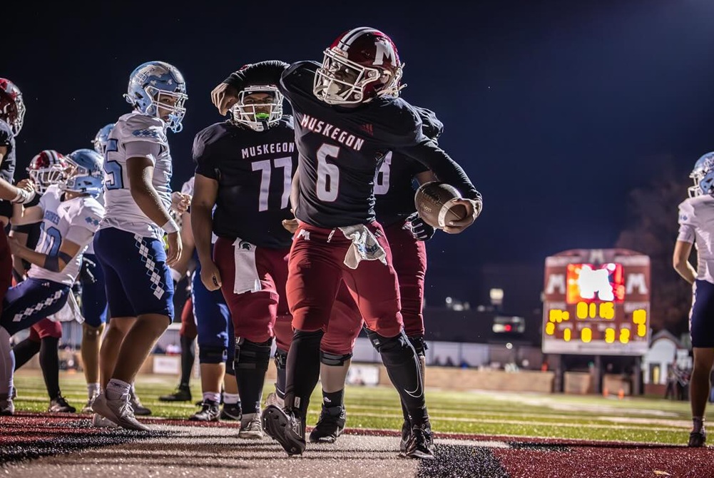 Muskegon's Lamar Bradford celebrates his touchdown run during the Big Reds' 39-34 win over Mona Shores on Friday.