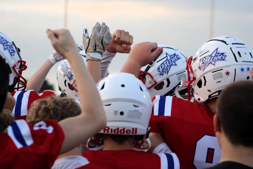 St. Helen Charlton Heston players huddle on a game day this season.