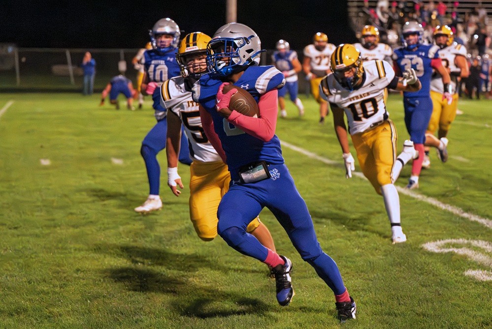 Saginaw Nouvel Catholic Central's Sean Foley (2) breaks down the sideline during a Week 7 game against Ithaca.