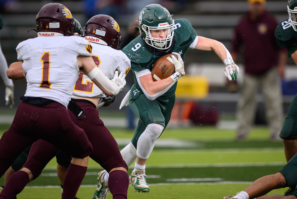 Portland St. Patrick running back Brady Leonard (9) accelerates through a hole during the first quarter of his team’s 8-Player Semifinal win Saturday over Deckerville.