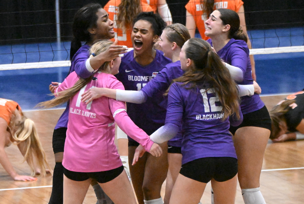 Bloomfield Hills players celebrate their five-set comeback win over Rockford on Thursday at Kellogg Arena.