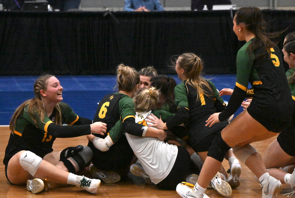 Flat Rock players pile onto the Kellogg Arena floor after clinching their first trip to the MHSAA Finals on Friday.