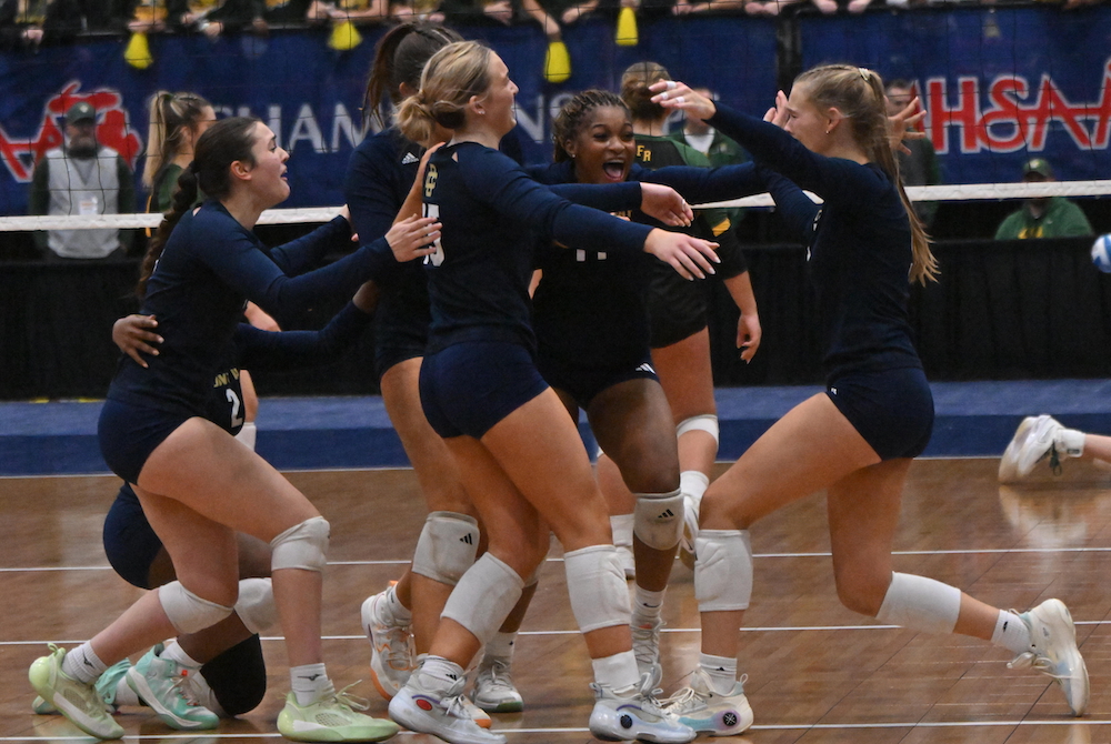 Detroit Country Day players celebrate their repeat championship Saturday at Kellogg Arena.