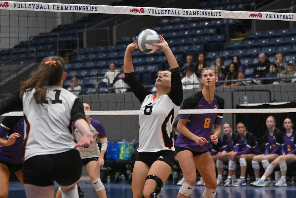 Kingsley’s Sarah Wooer (6) sets for teammate Jenna Middleton (11) on Saturday as Kalamazoo Christian’s Elliana VanDusen prepares to defend. 