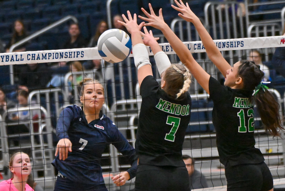 Fowler’s Skylar Fowler (7) powers a kill past Mendon’s Gracie Schultz (7) and Sabrina Monroy (12) during Saturday’s Division 4 Final. 