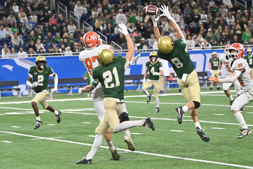 Lumen Christi’s Johnny Walters (8) and Nolan Huff (21) break up a pass intended for Kingsley’s Alex Figueroa (87) on Friday at Ford Field.