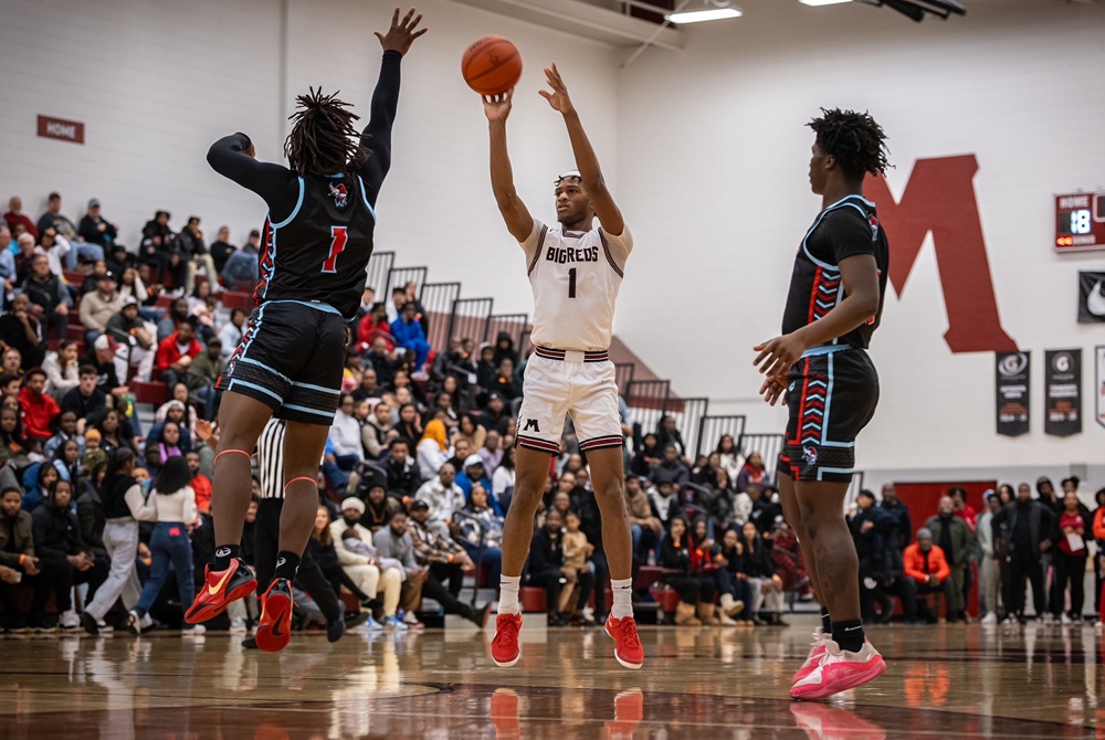 James Martin (1) puts up a shot from the top of the key during Muskegon’s matchup with Lansing Everett last season.