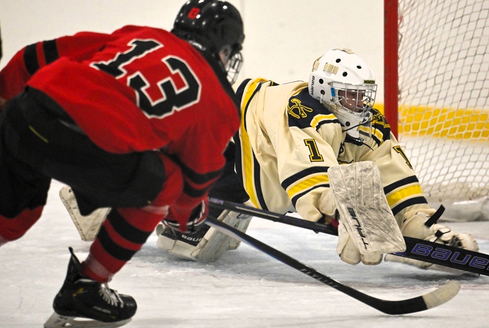 Marquette's Skyler Blackburn and Negaunee goalie Kurt O'Brien scramble for the puck during a Nov. 8 matchup.