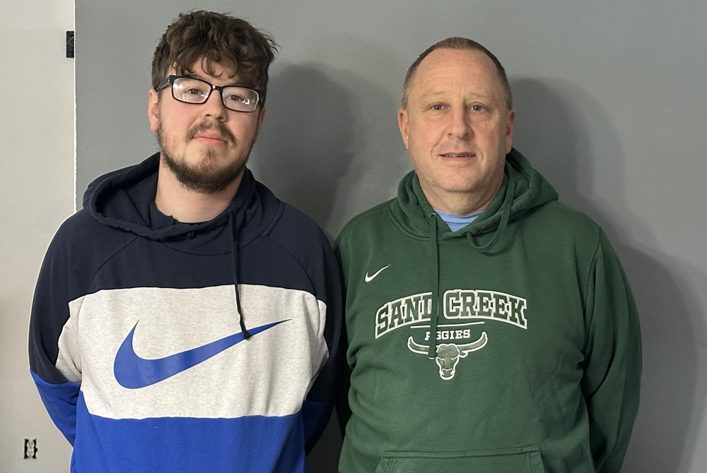 Britton Deerfield varsity girls basketball coach Zachary Zyla poses for a photo with his father Mike Zyla, right, the varsity girls basketball coach at Sand Creek.