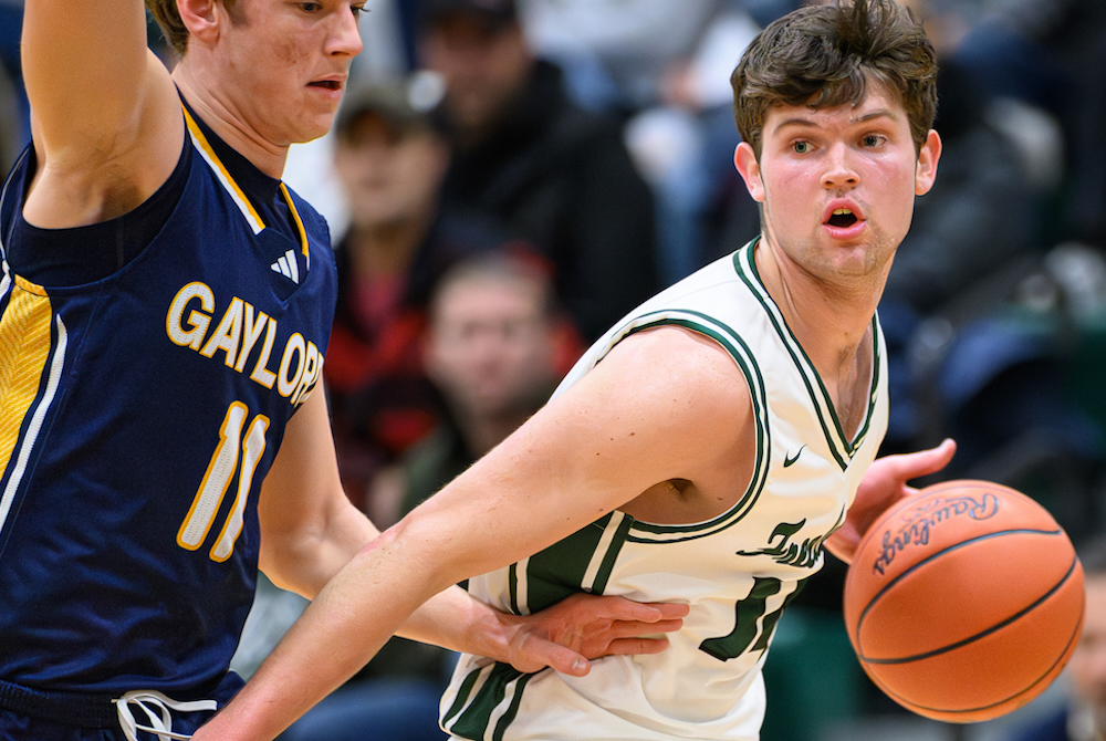 Freeland senior forward Wilson Huckeby, right, navigates around a defender during the first quarter of last week's 70-47 Falcons win over Gaylord. 