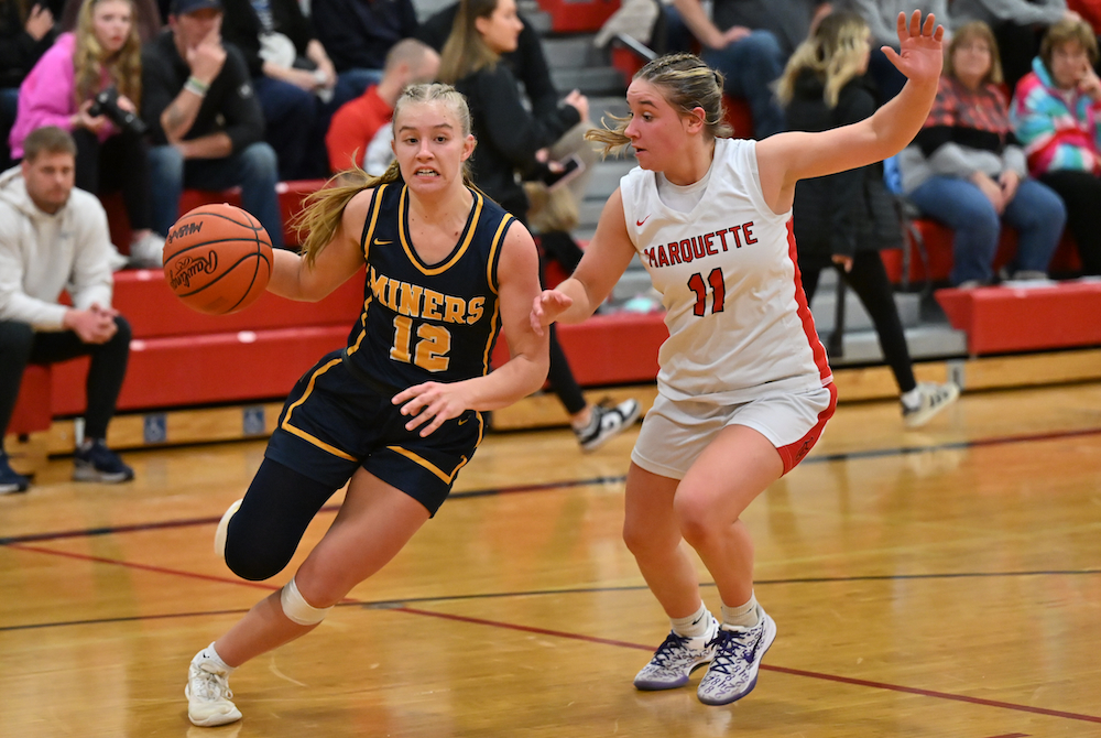 Negaunee's Gretel Johnson drives to the net while being defended by Lexi Curran during the Miners' 43-26 win over Marquette on Dec. 9. 