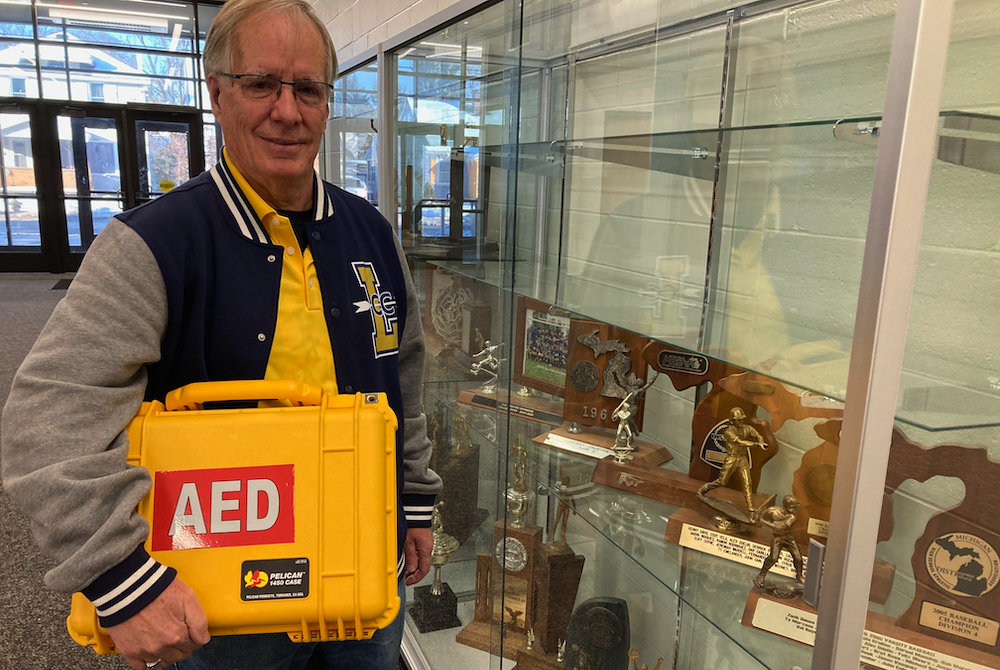 Wyoming Lee cross country/track coach Greg Popma carries his school’s portable AED that is brought to school sporting events. 