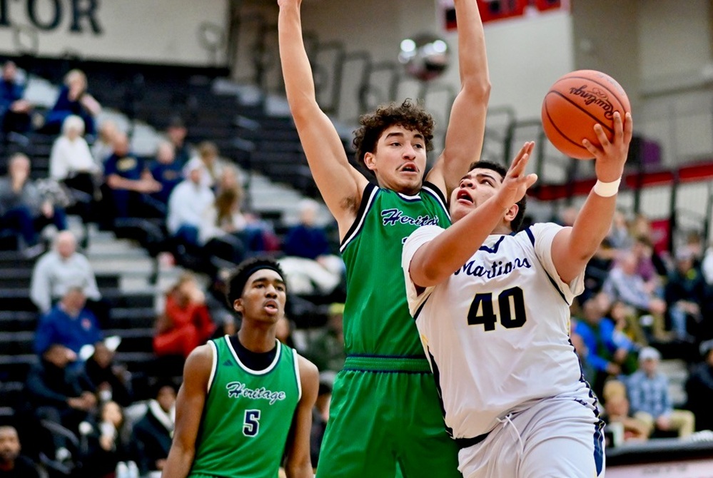 Goodrich’s Miles Washington (40) works to get a shot up past a Saginaw Heritage defender during the Martians’ 65-48 win Jan. 3. 