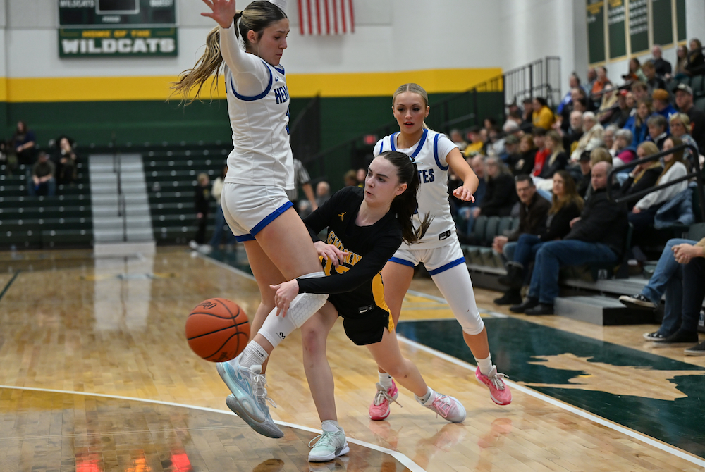 Gwinn's Alayna Soyring passes the ball around Ishpeming' Jenessa Eagle (left) and Ava Jo Hares (right) during their teams’ matchup Jan. 6 at Northern Michigan University.