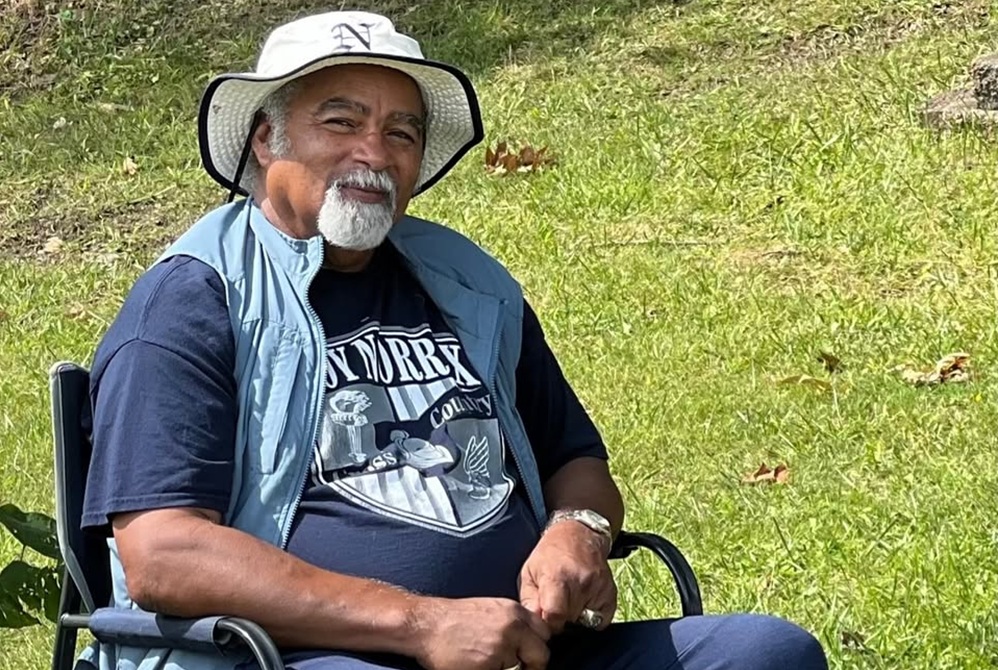 Ted Duckett sits for a photo, wearing Loy Norrix gear. 