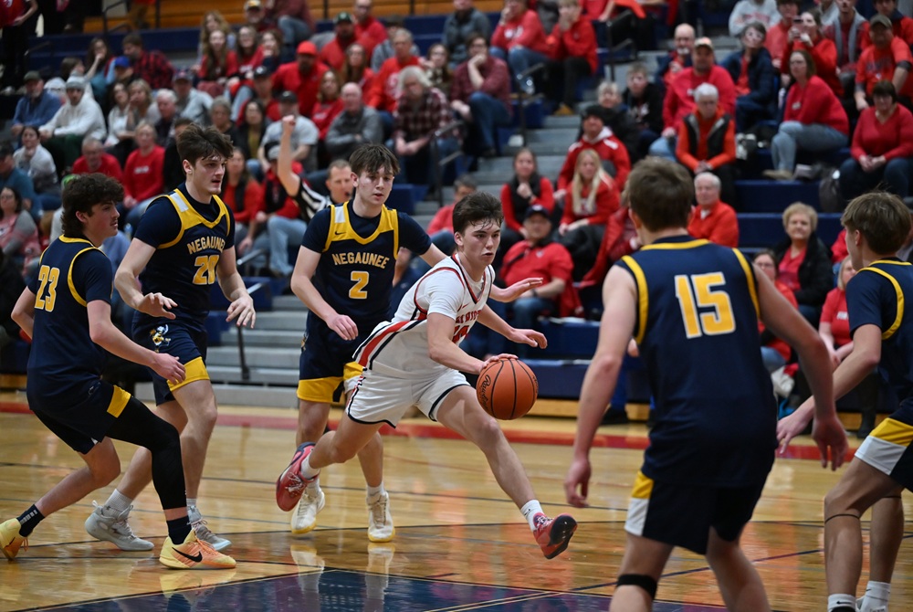 Surrounded by Negaunee’s entire lineup, Ishpeming Westwood's Ethan Marta makes a move into the lane to score two points during a 65-41 win Friday; he set a school record with 46 points. 